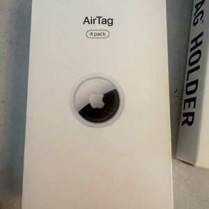 four pack of AirTags brand new inbox also AirTag holders for pack.